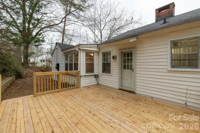 a view of a house with a wooden deck