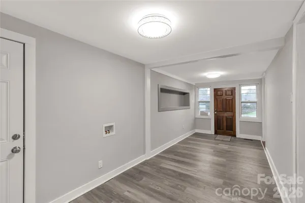 a view of an empty room with wooden floor