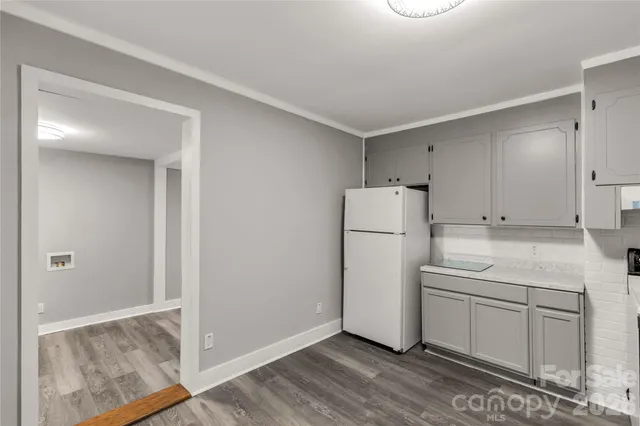 a utility room with cabinets washer and dryer