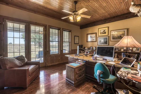 a spacious bathroom with a granite countertop sink a mirror and shower