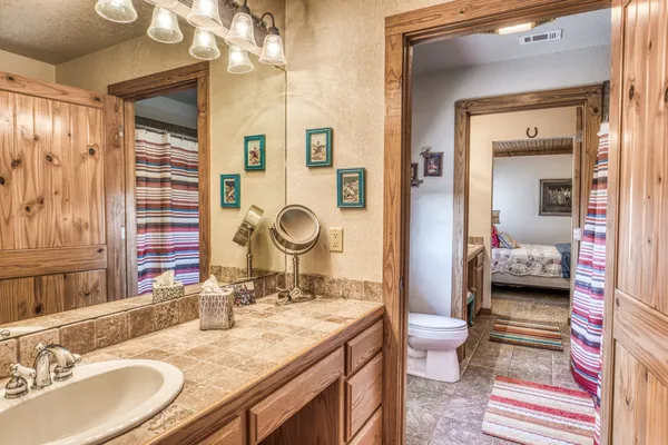 a bedroom with a bed wooden floor and window