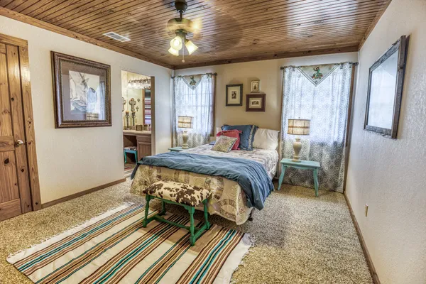 a bedroom with a bed and a chandelier