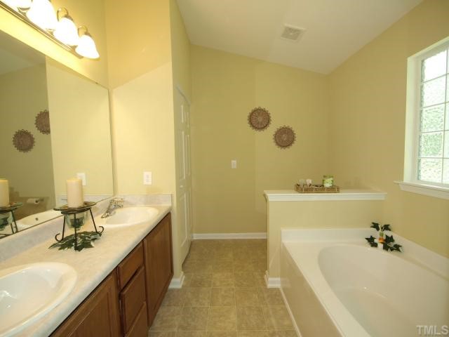2886 Filbert Street Raleigh, NC 27610 - Photo 5 of 10 Retreat to your Master Bath, which offers dual vanities, privacy window, garden tub, and separate shower.