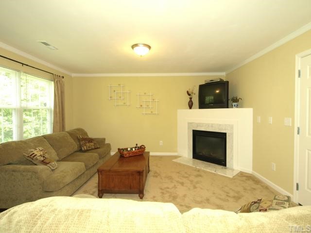 2886 Filbert Street Raleigh, NC 27610 - Photo 6 of 10 The Family Room boasts a gas fireplace, new carpet/paint and lots of natural light.