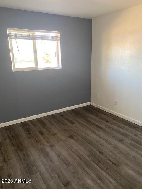 15 East Erie Drive Tempe, AZ 85282 - Photo 5 of 12 an empty room with wooden floor and windows