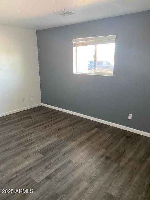 15 East Erie Drive Tempe, AZ 85282 - Photo 7 of 12 an empty room with wooden floor and windows