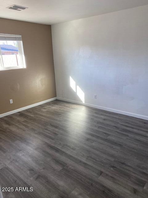 15 East Erie Drive Tempe, AZ 85282 - Photo 8 of 12 an empty room with wooden floor and windows