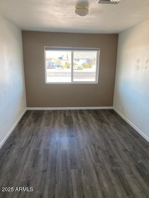 15 East Erie Drive Tempe, AZ 85282 - Photo 10 of 12 an empty room with wooden floor and windows