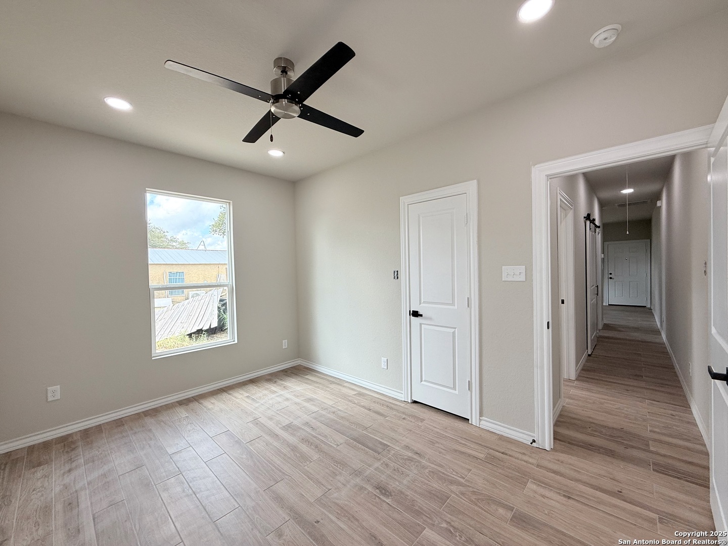 3274 Interstate 35 Natalia, TX 78059 - Photo 11 of 44 a view of an empty room with wooden floor and a window