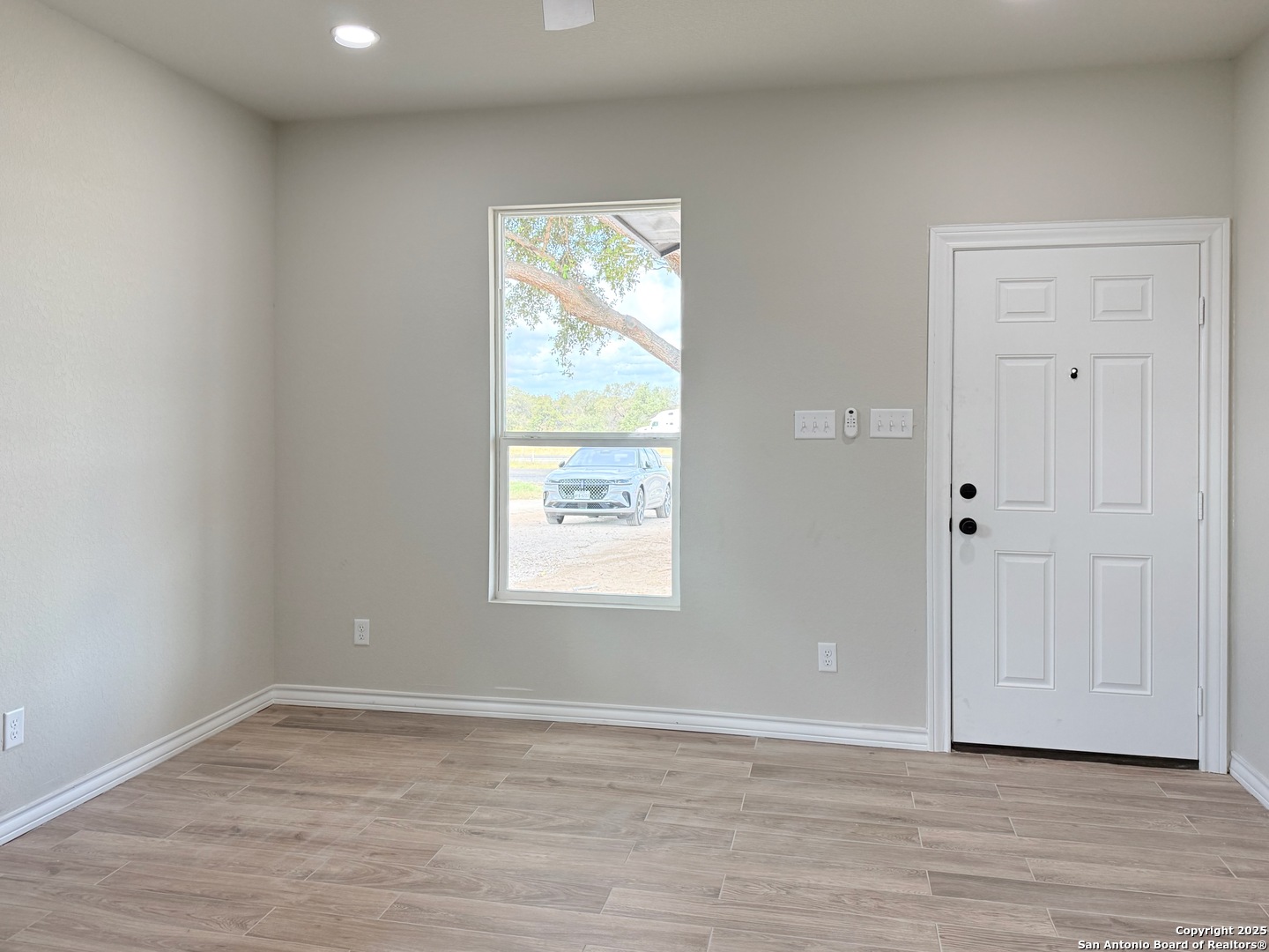 3274 Interstate 35 Natalia, TX 78059 - Photo 17 of 44 an empty room with wooden floor and windows