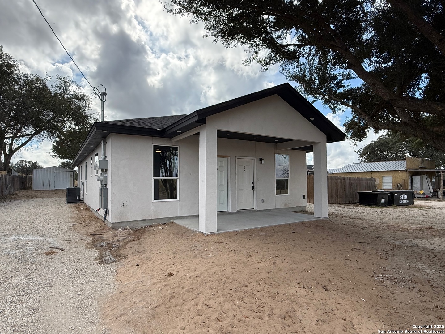 3274 Interstate 35 Natalia, TX 78059 - Photo 2 of 44 a front view of a house with a yard and garage
