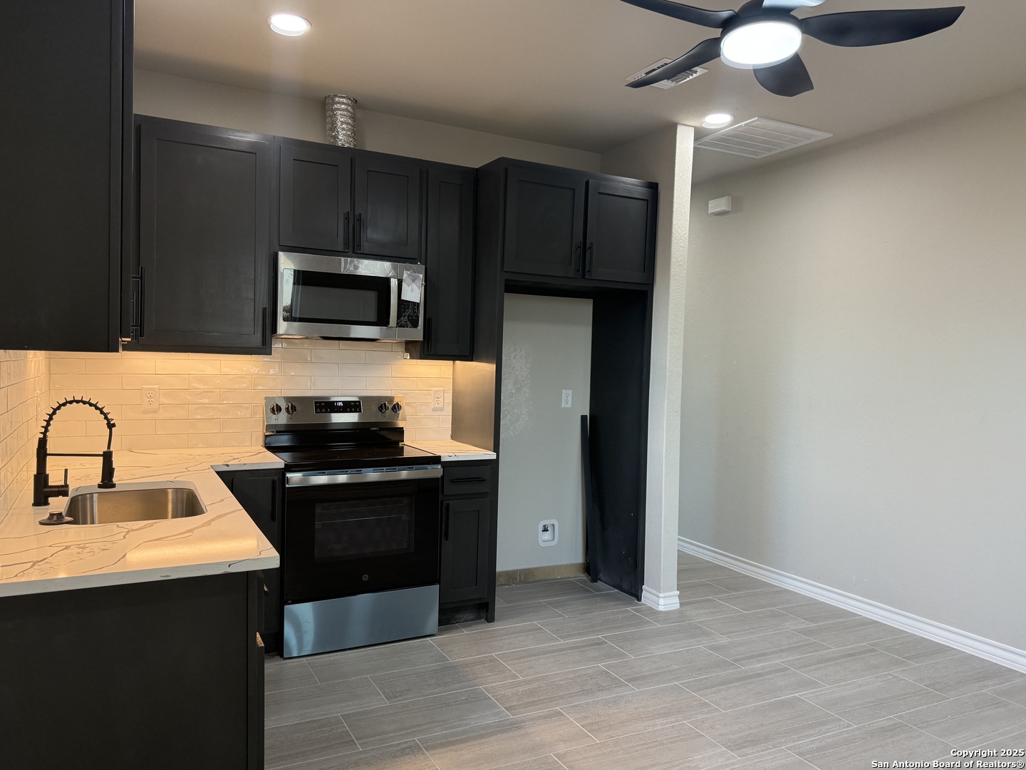 3274 Interstate 35 Natalia, TX 78059 - Photo 21 of 44 a kitchen with a sink appliances and cabinets