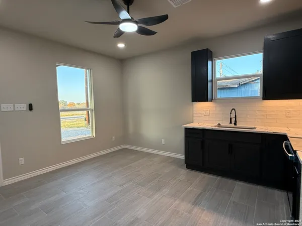 a kitchen with kitchen island granite countertop a cabinets and steel appliances