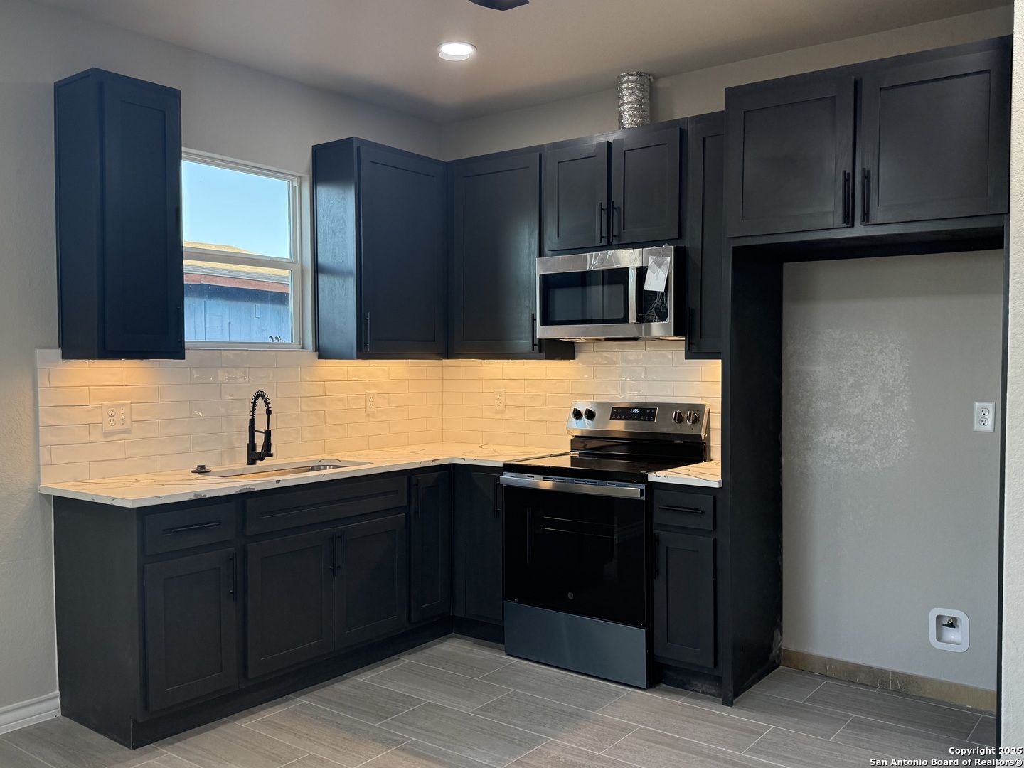 3274 Interstate 35 Natalia, TX 78059 - Photo 25 of 44 a kitchen with kitchen island granite countertop a cabinets and steel appliances
