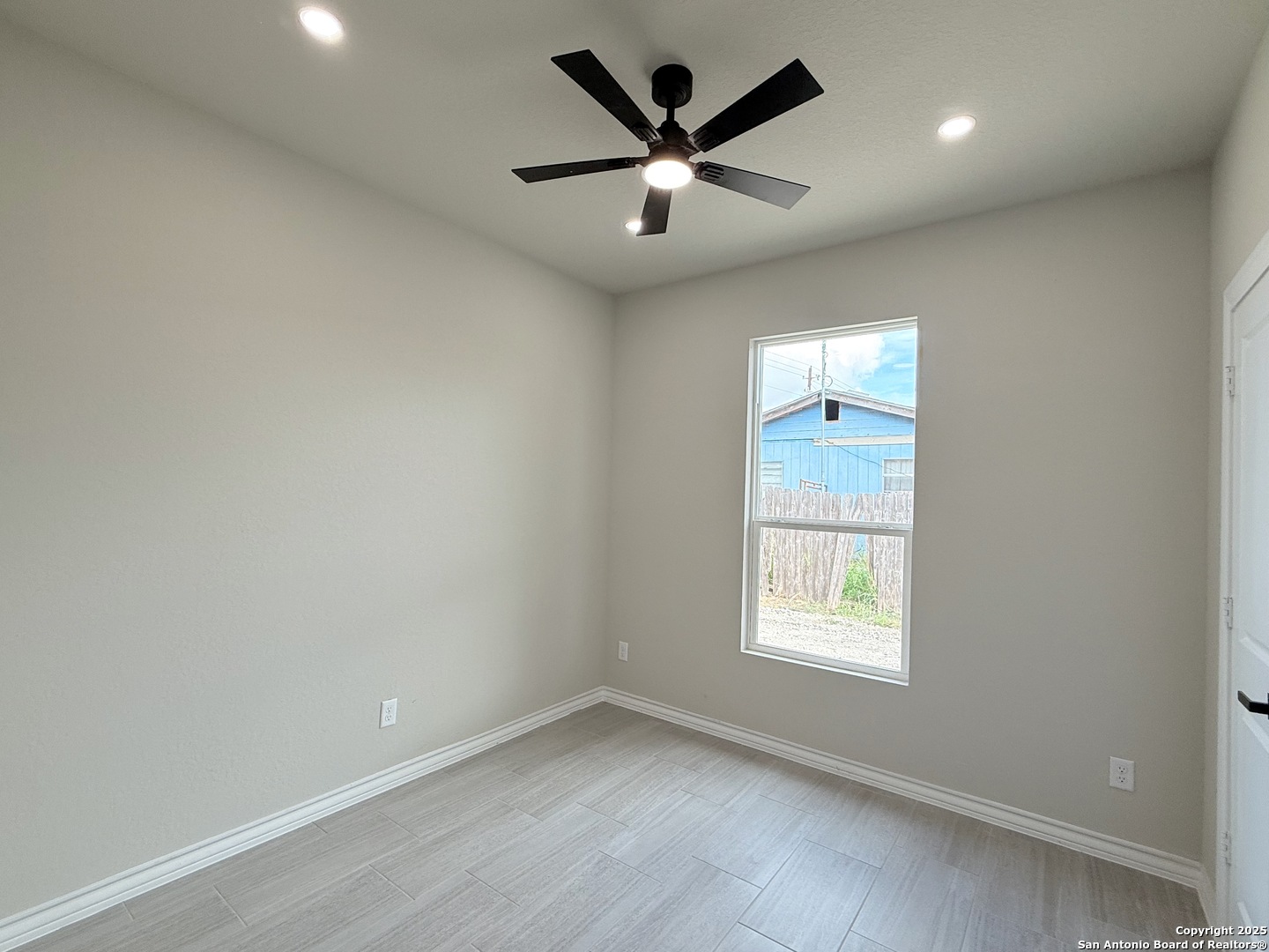 3274 Interstate 35 Natalia, TX 78059 - Photo 27 of 44 an empty room with a window and a fan