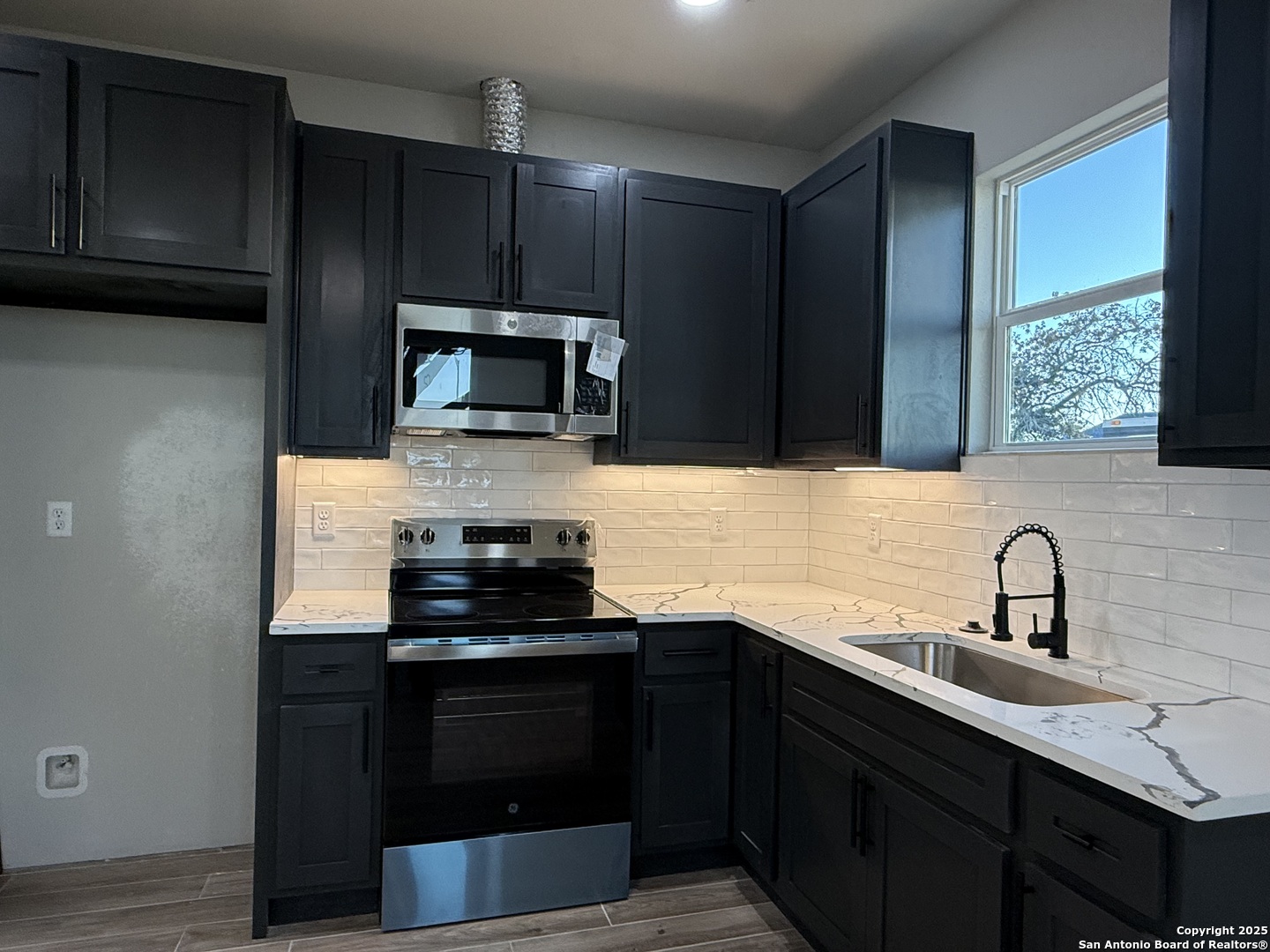 3274 Interstate 35 Natalia, TX 78059 - Photo 4 of 44 a kitchen with a sink stove and microwave