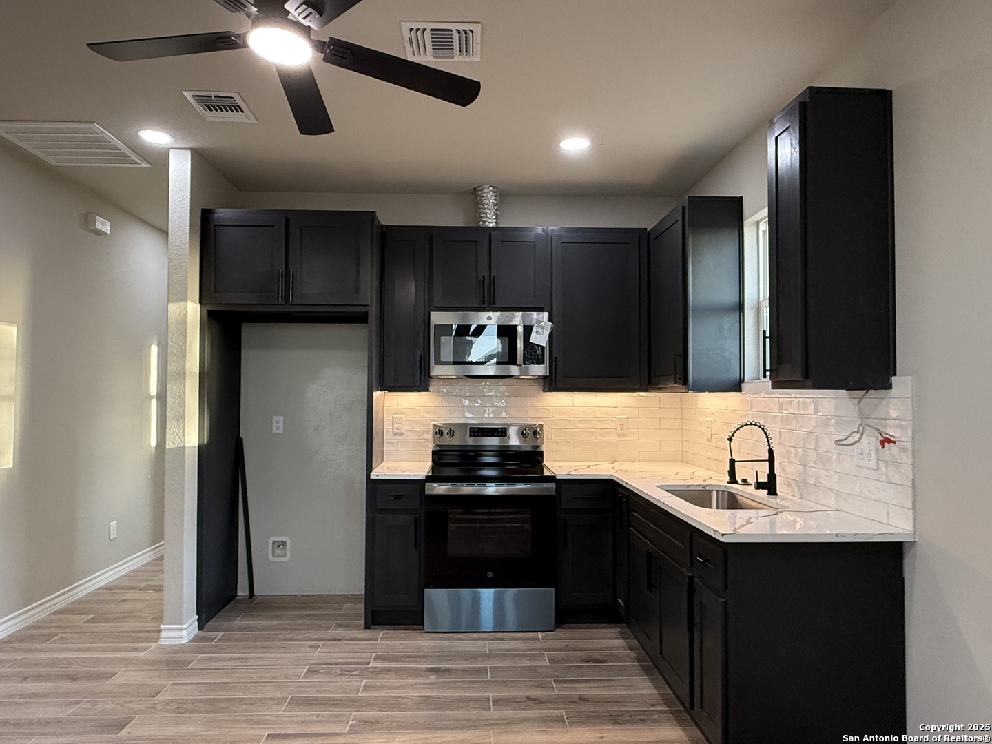 3274 Interstate 35 Natalia, TX 78059 - Photo 5 of 44 a kitchen with kitchen island granite countertop stainless steel appliances and sink