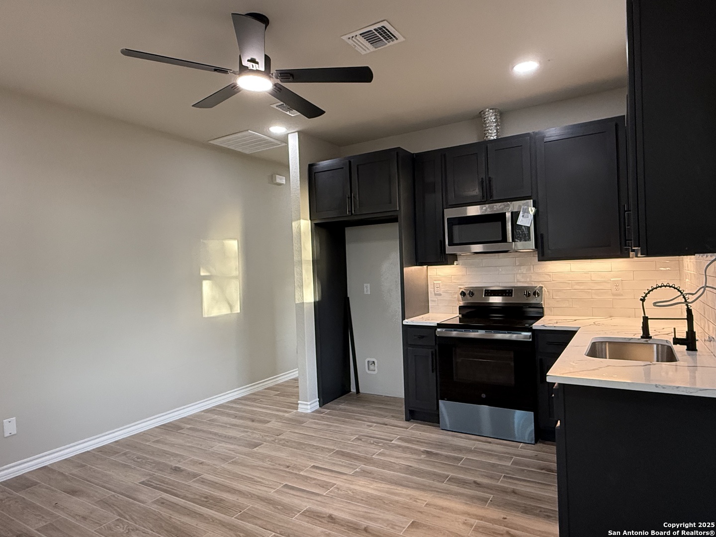 3274 Interstate 35 Natalia, TX 78059 - Photo 6 of 44 a kitchen with kitchen island granite countertop stainless steel appliances cabinets a sink and a counter top space