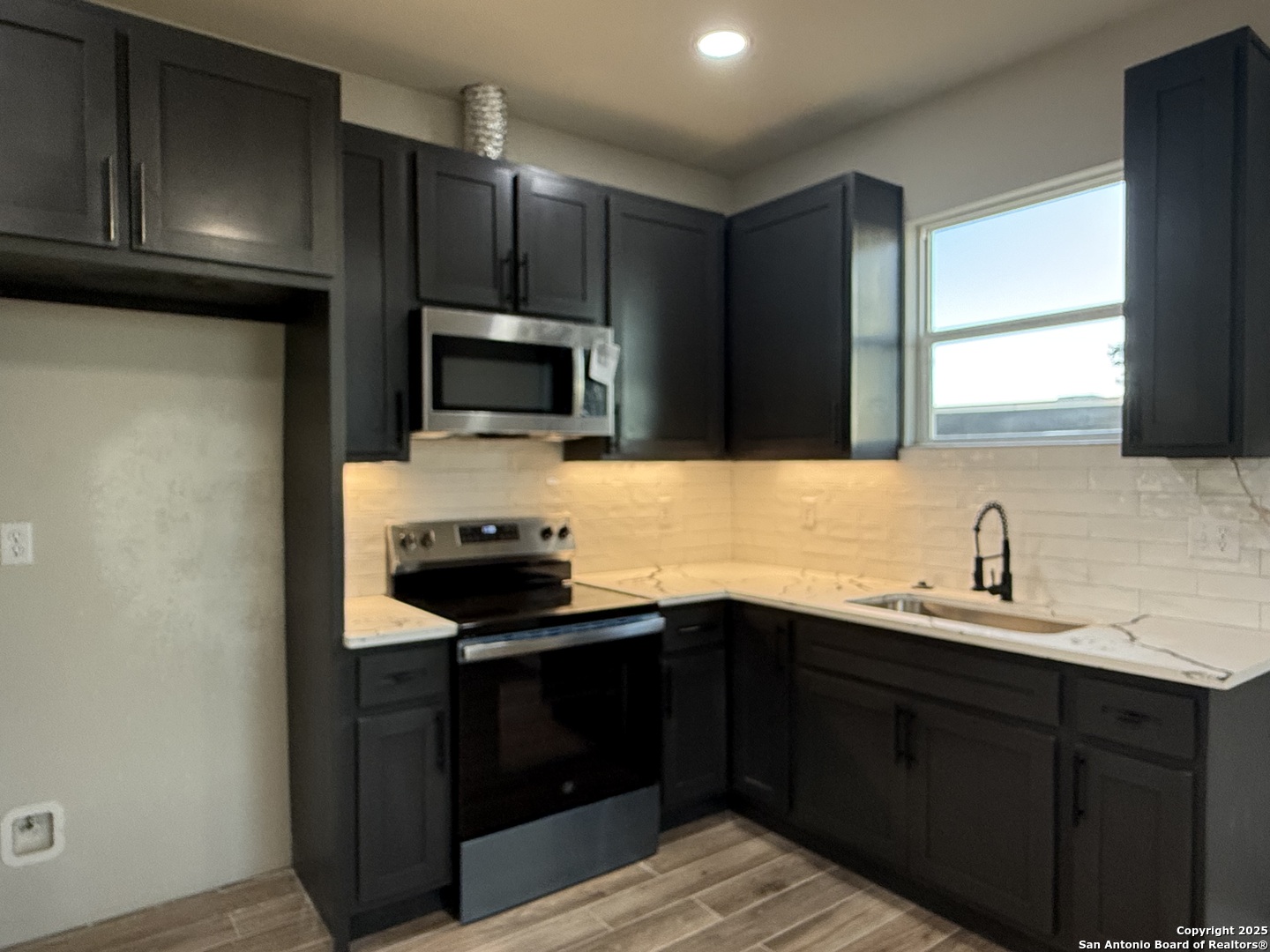 3274 Interstate 35 Natalia, TX 78059 - Photo 7 of 44 a kitchen with a sink and a stove top oven
