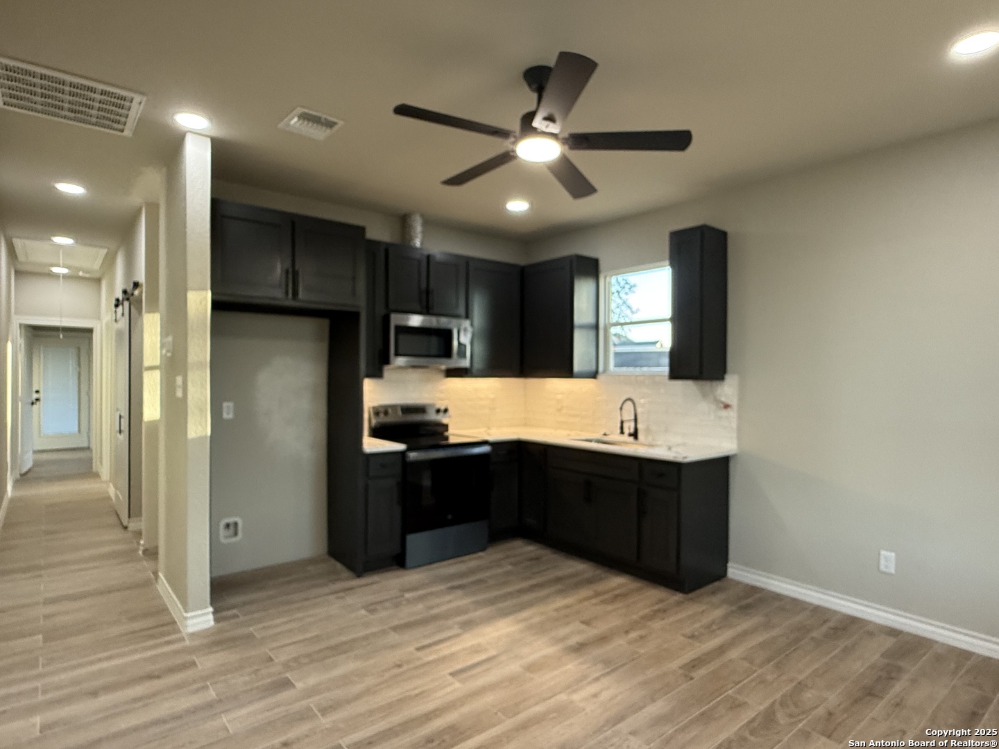 3274 Interstate 35 Natalia, TX 78059 - Photo 8 of 44 a kitchen with granite countertop a refrigerator and a sink