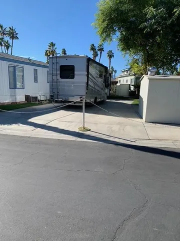 a white house that has a tree on the side of it