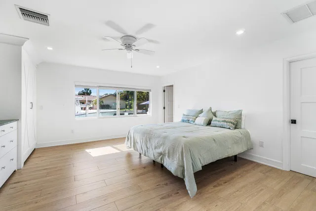 a bedroom with a large bed and a window