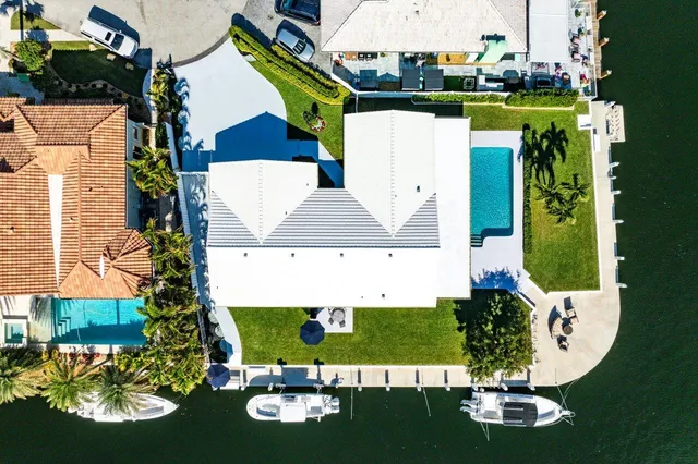 an aerial view of a house with swimming pool patio and outdoor seating