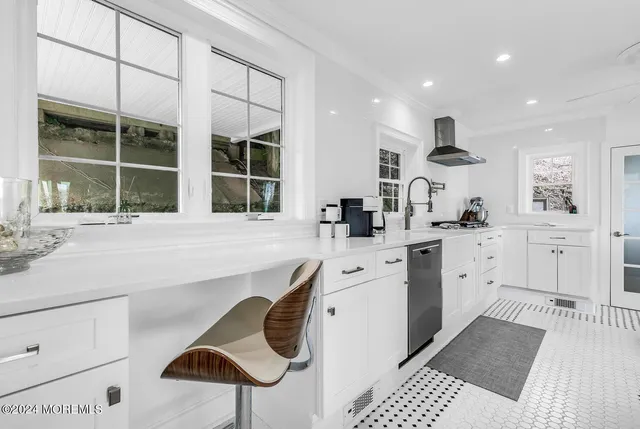 a kitchen with stainless steel appliances kitchen island granite countertop a sink and cabinets