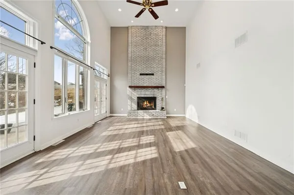 a view of an empty room with a fireplace and a window