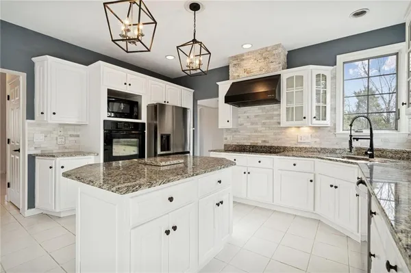 a kitchen with stainless steel appliances granite countertop a sink and dishwasher a stove with wooden floor