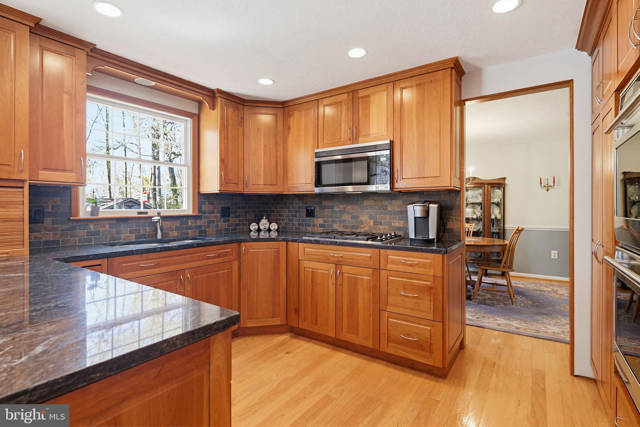 1017 Windmill Lane Silver Spring, MD 20905 - Photo 15 of 57 a kitchen with stainless steel appliances granite countertop a stove a sink and a microwave