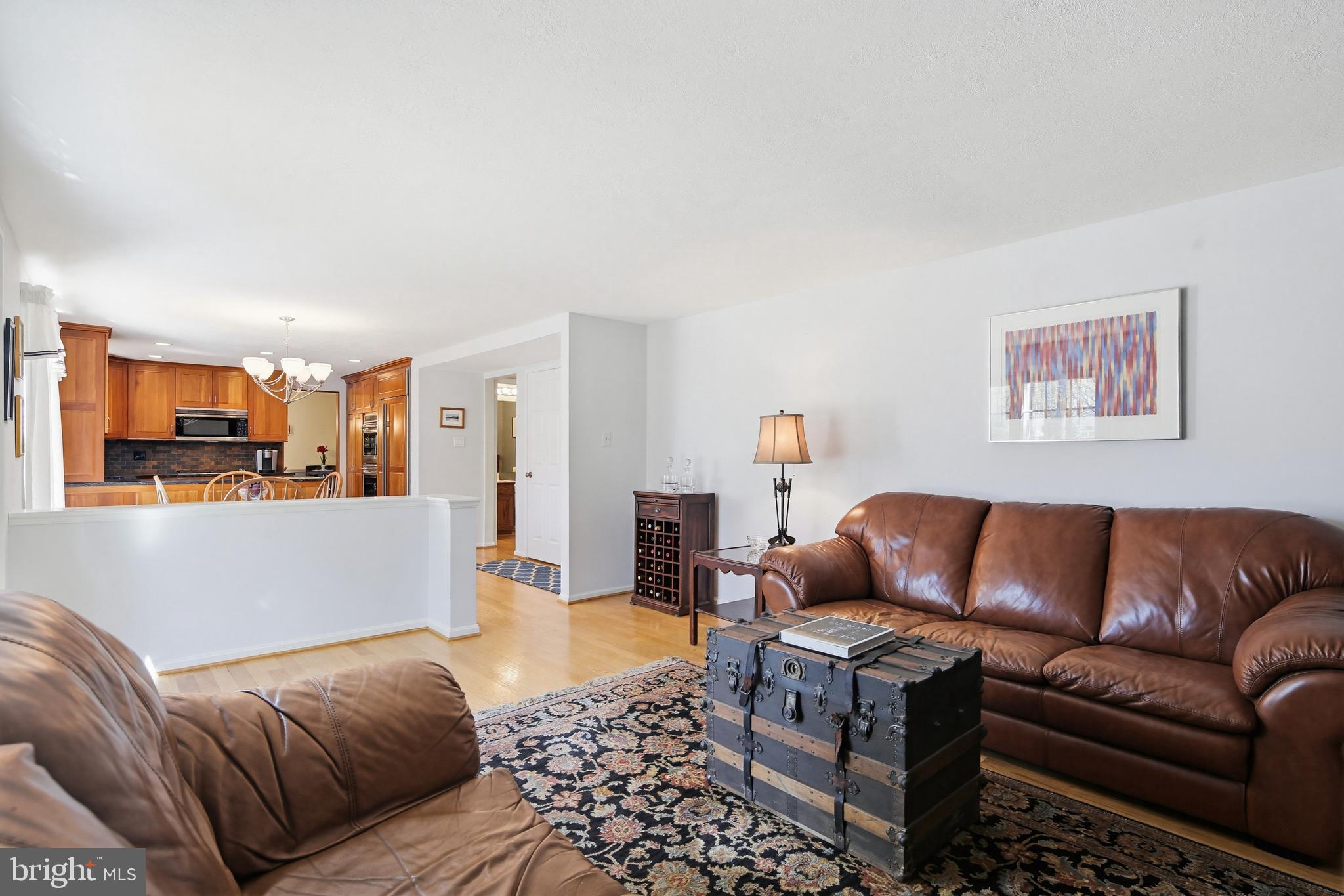 1017 Windmill Lane Silver Spring, MD 20905 - Photo 20 of 57 a living room with furniture a couch and kitchen view