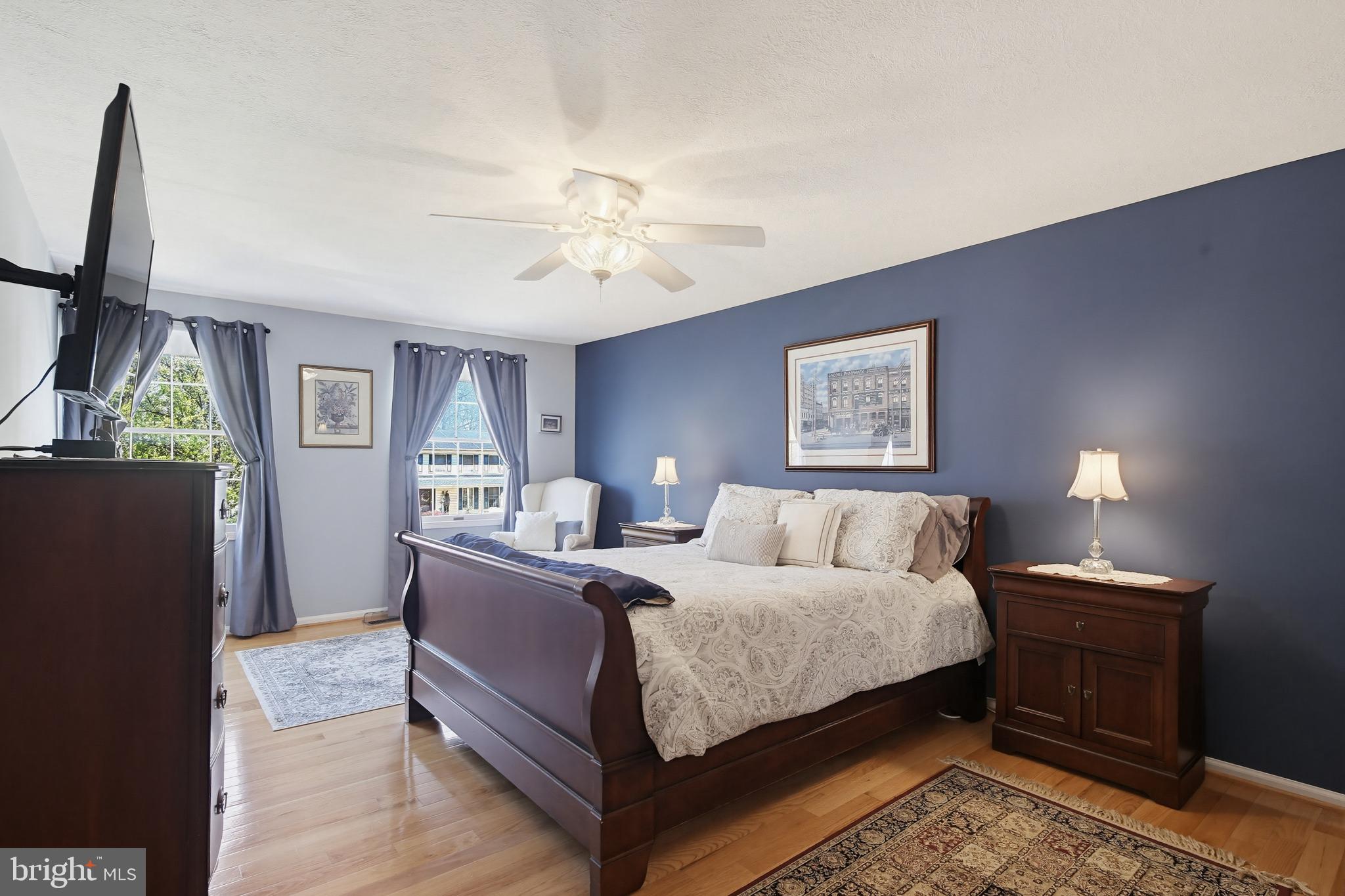1017 Windmill Lane Silver Spring, MD 20905 - Photo 22 of 57 a bedroom with a bed lamps and a mirror