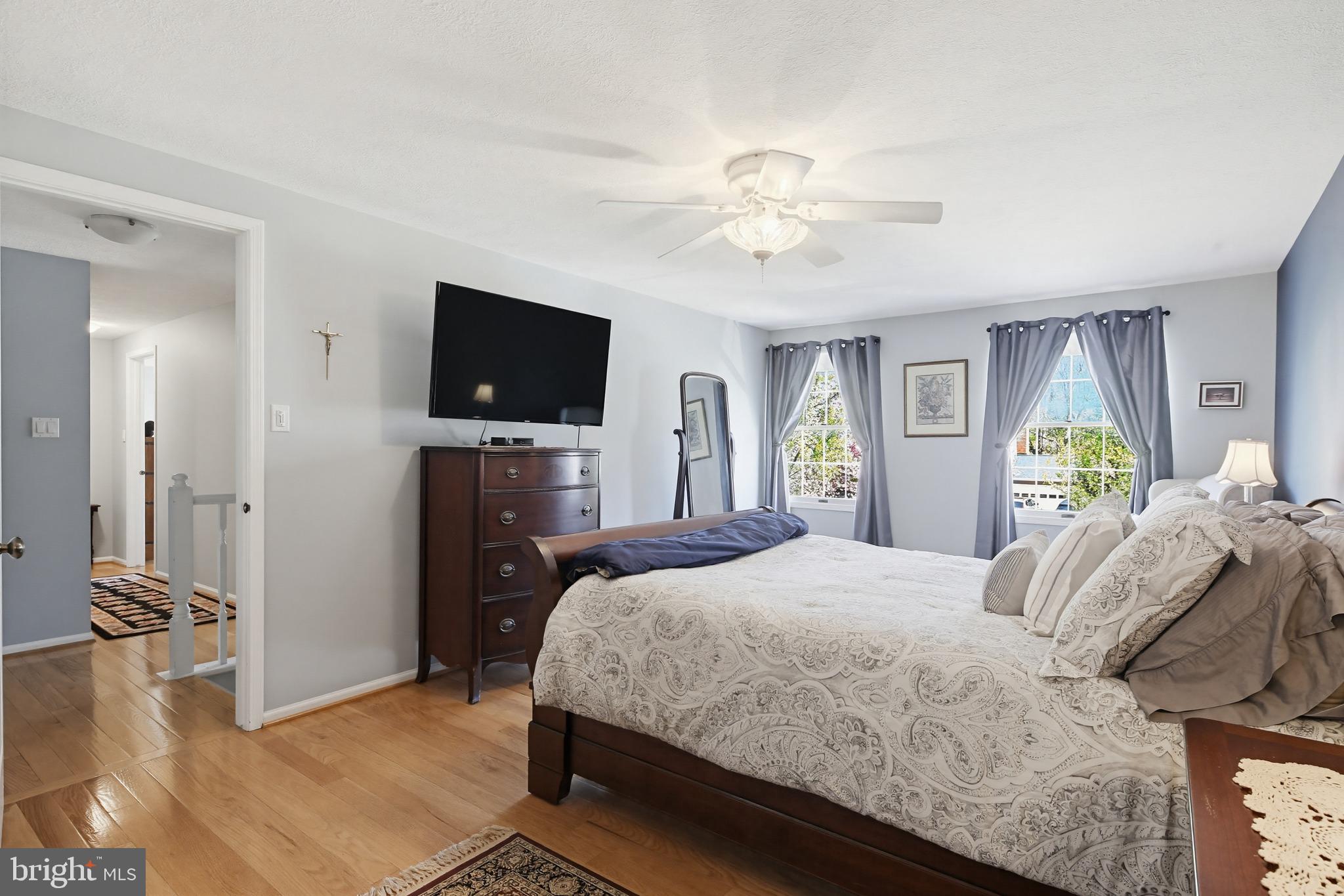 1017 Windmill Lane Silver Spring, MD 20905 - Photo 23 of 57 a bedroom with a bed and a flat tv screen on dresser