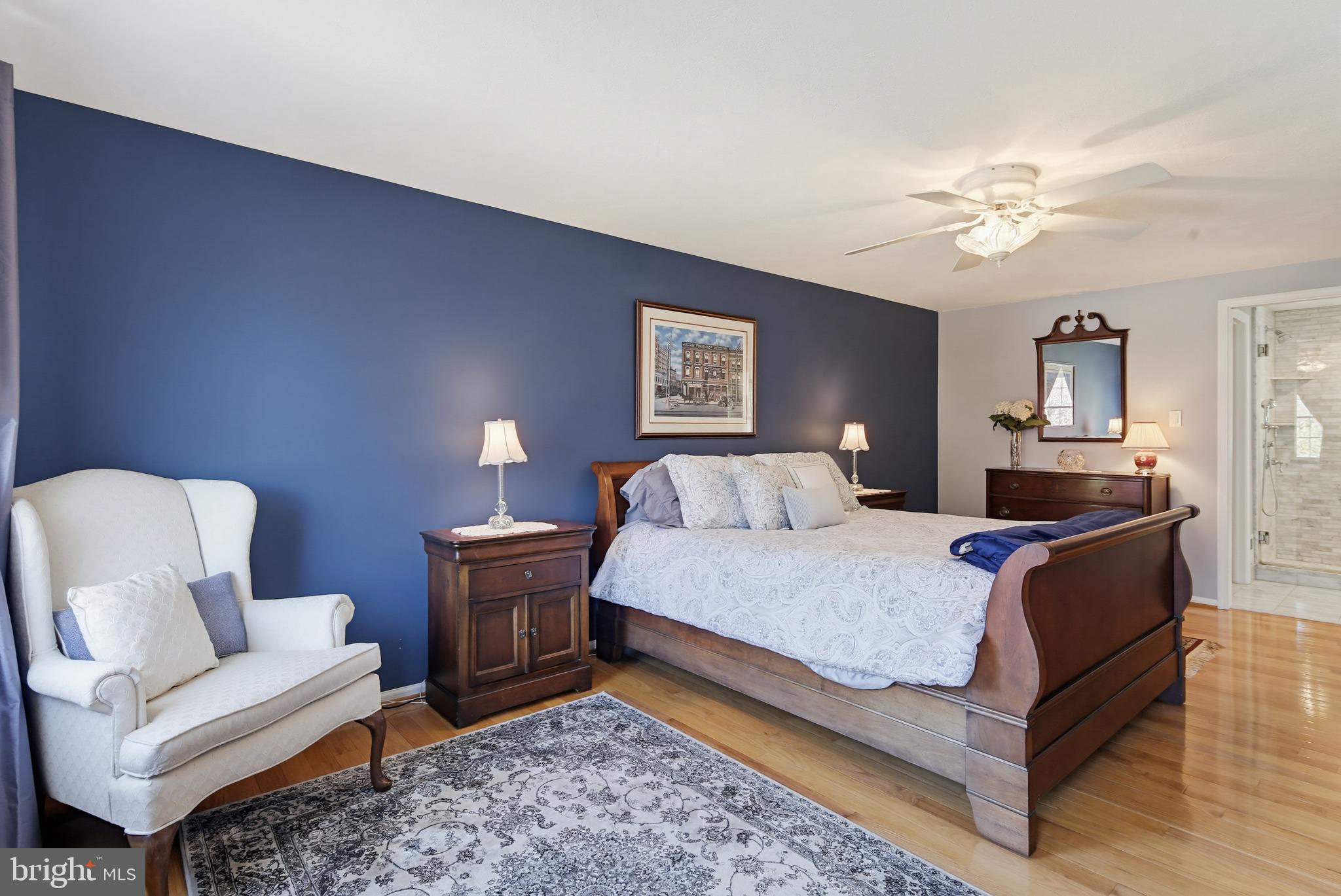 1017 Windmill Lane Silver Spring, MD 20905 - Photo 24 of 57 a spacious bedroom with a bed and a couch