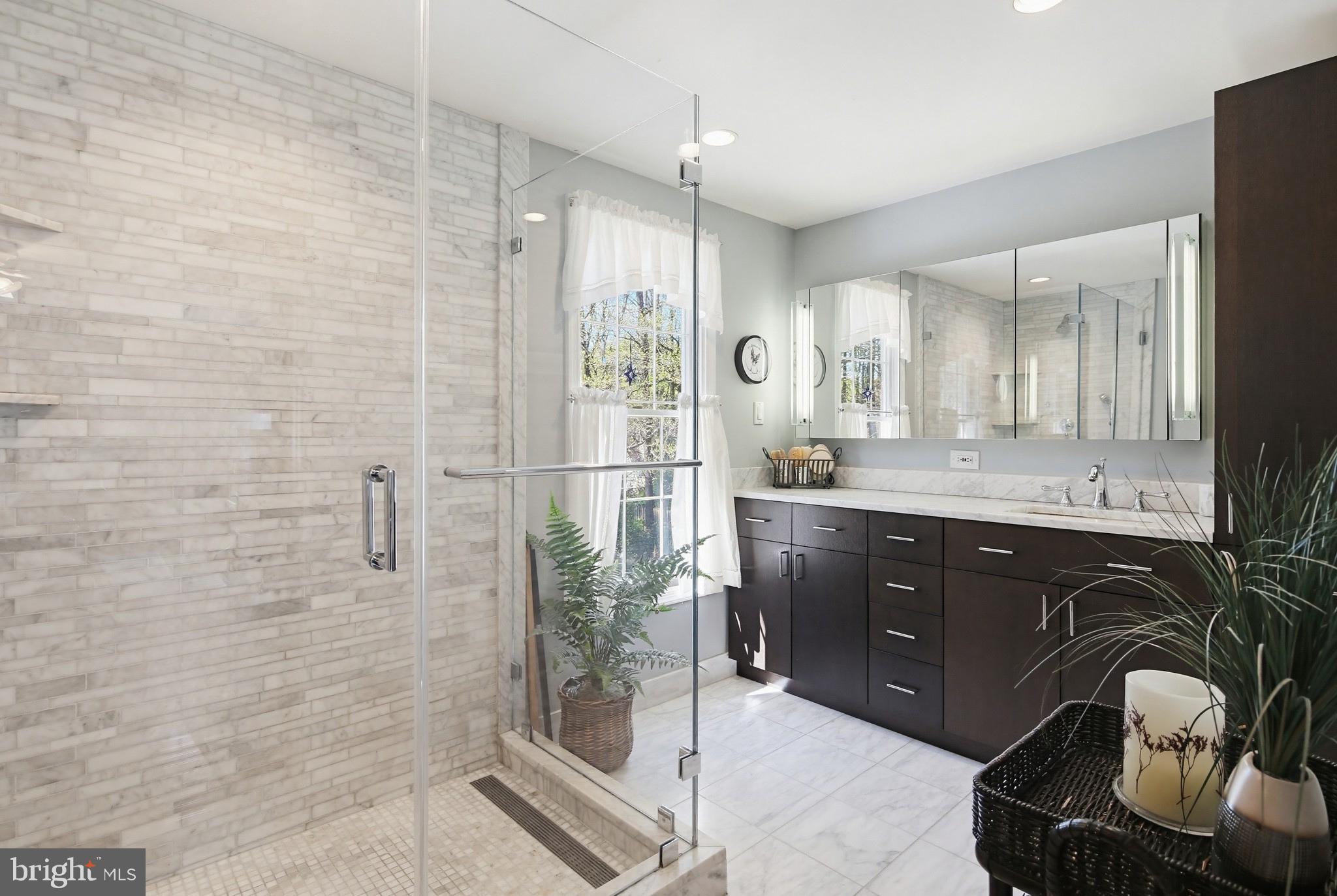 1017 Windmill Lane Silver Spring, MD 20905 - Photo 25 of 57 a bathroom with a granite countertop sink a mirror and shower