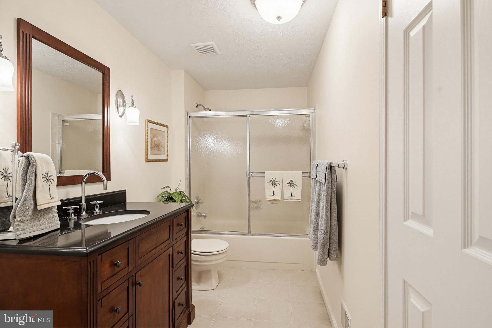 1017 Windmill Lane Silver Spring, MD 20905 - Photo 32 of 57 a bathroom with a double vanity sink toilet and shower