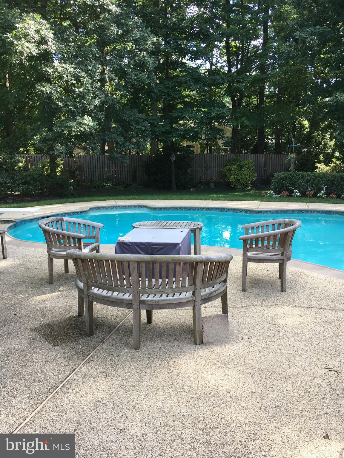 1017 Windmill Lane Silver Spring, MD 20905 - Photo 49 of 57 a backyard with a bench and lake view