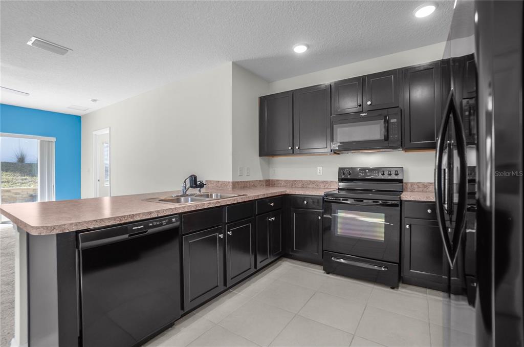 3525 North Burroughs Path Beverly Hills, FL 34465 - Photo 3 of 49 a kitchen with stainless steel appliances granite countertop a sink and a stove