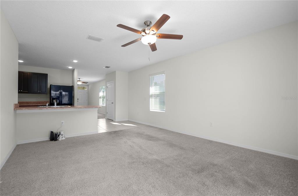 3525 North Burroughs Path Beverly Hills, FL 34465 - Photo 8 of 49 a view of an empty room with kitchen and a ceiling fan