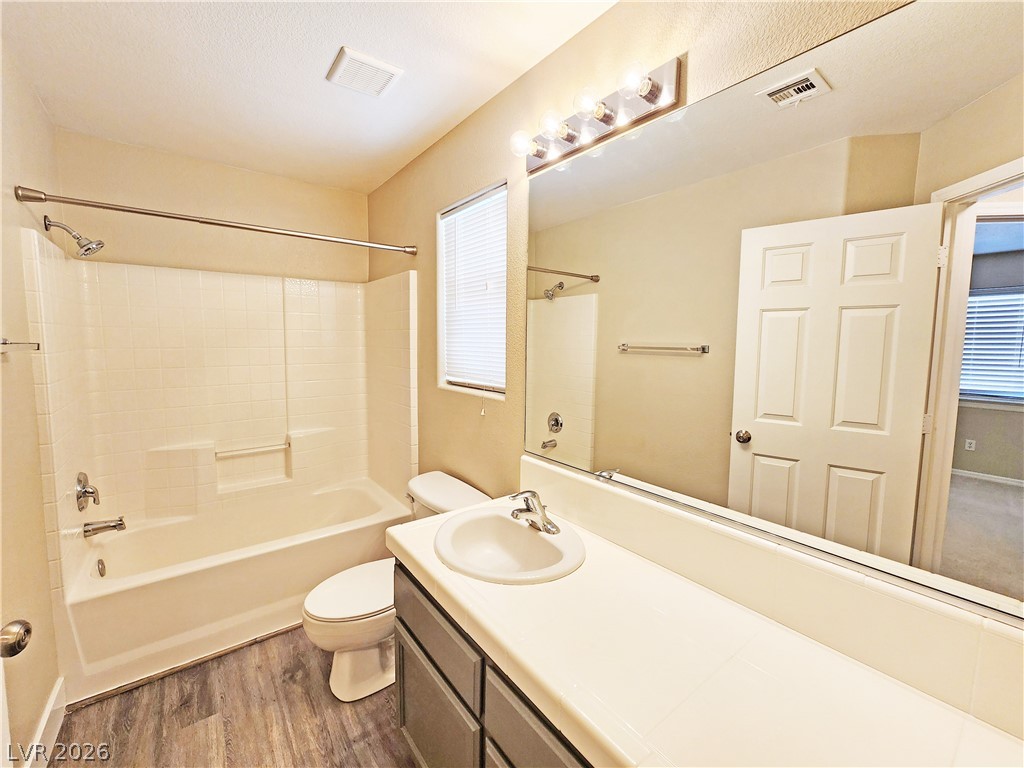4591 Stoneham Street Pahrump, NV 89061 - Photo 37 of 42 A pristine bathroom featuring a combined shower and tub, with an elegant vanity.
