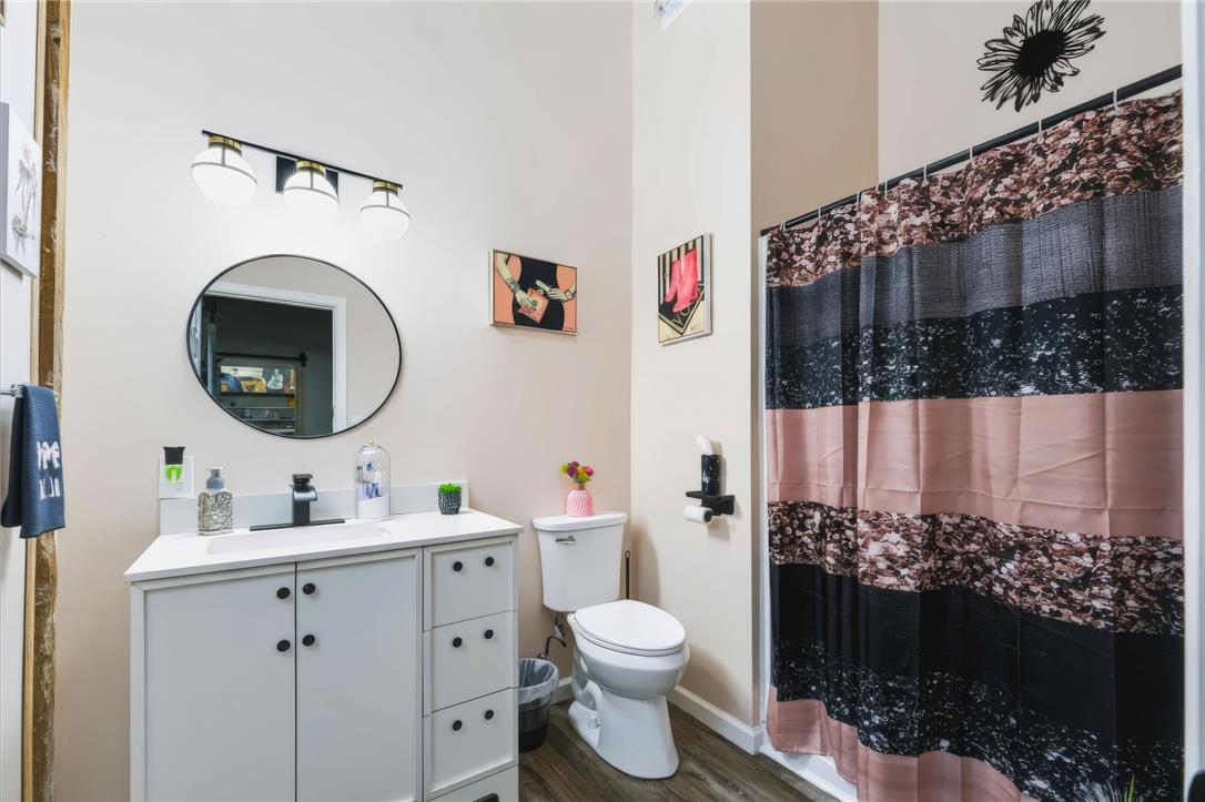 74 Turkey Road Kempton, PA 19529 - Photo 48 of 65 GUEST HOME - A well-appointed bath features a modern vanity, circular mirror, and complementary shower curtain.
