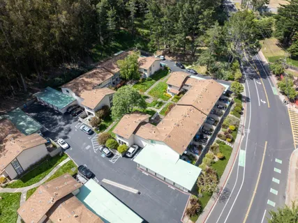 an aerial view of a house with a yard