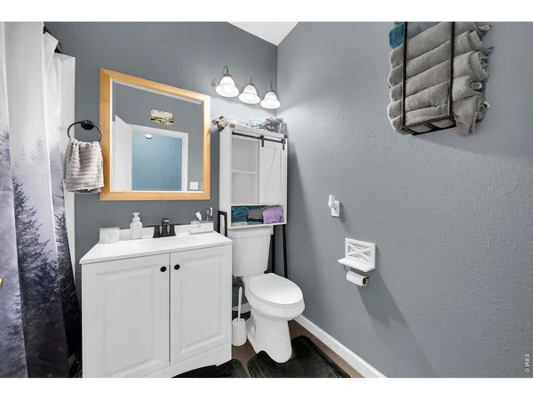 a bathroom with a sink a toilet and mirror