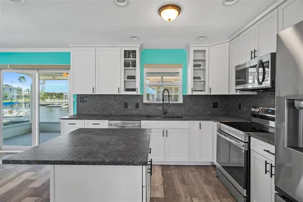 a kitchen with stainless steel appliances a refrigerator and a sink