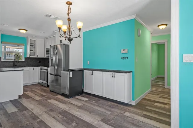 a kitchen with a sink and a refrigerator