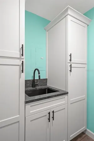 a view of a hallway with wooden floor and entryway