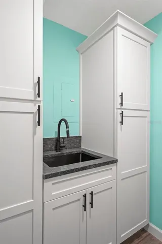 a view of a hallway with wooden floor and entryway