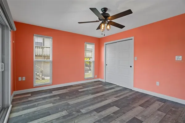 a view of a livingroom with a ceiling fan and window