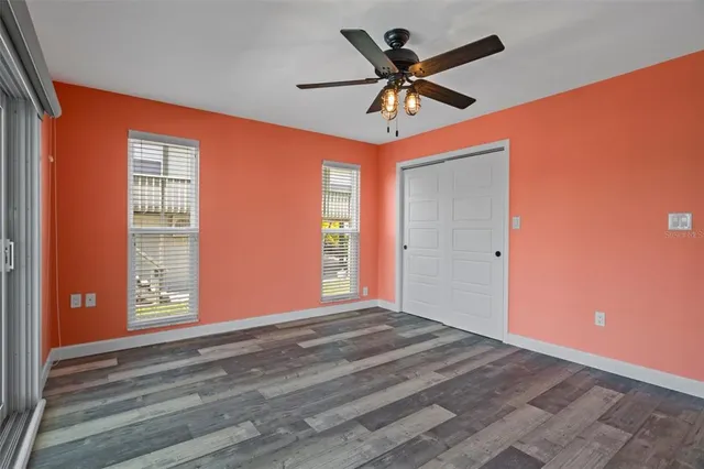 a view of a livingroom with a ceiling fan and window